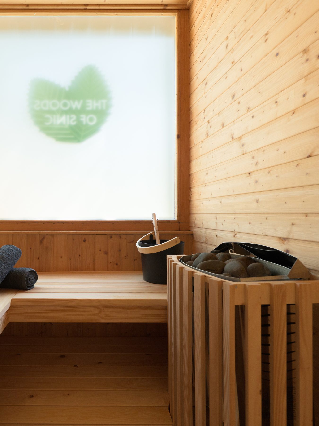Interior of a Finnish sauna with warm wood walls and dim, golden light