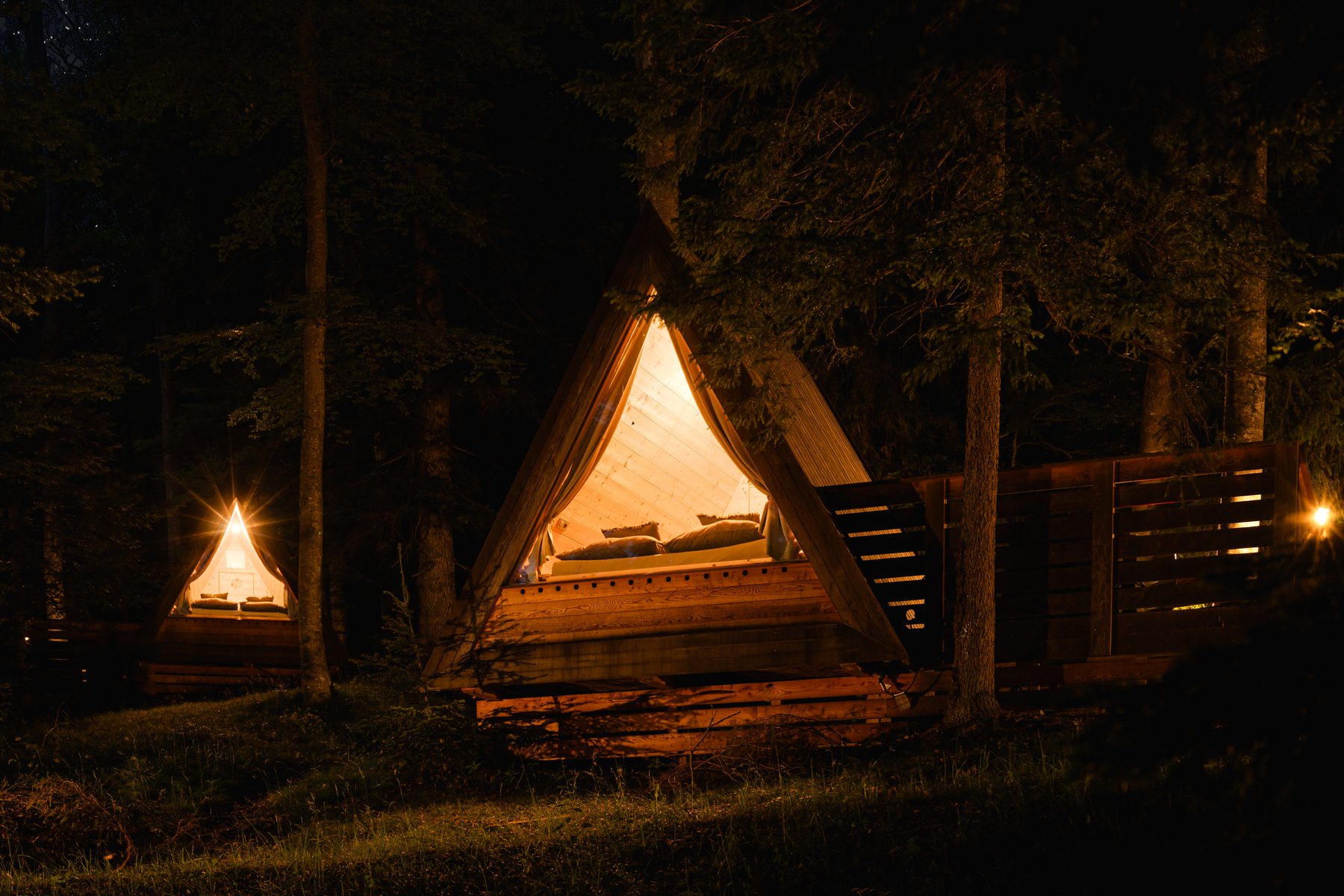 Cabin 1 — A-frame wooden exterior among spruce trees